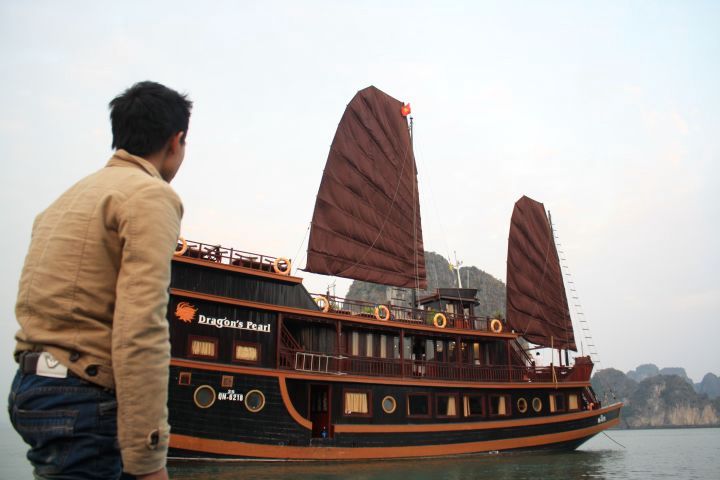 Picture of a man standing in front of the Dragon's Pearl boat